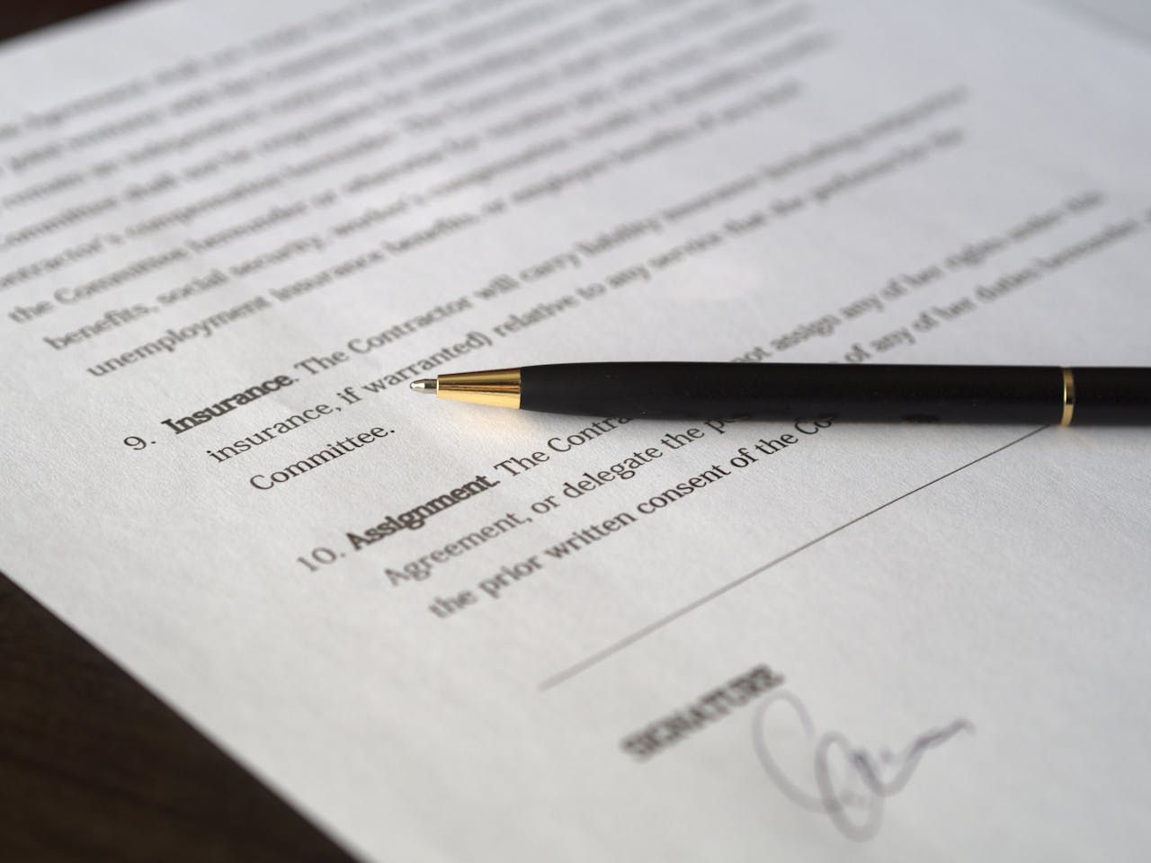Pen resting on an insurance policy document